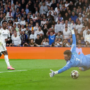 Real Madrid survive Benfica scare to reach last 16